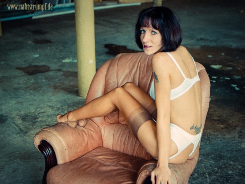 Stockinged Bea and the armchair. She is wearing real fully fashioned seamed stockings