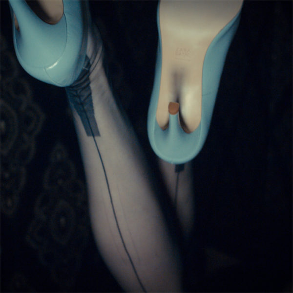 Dunkelblaue Nahtnylons und helle High Heels
