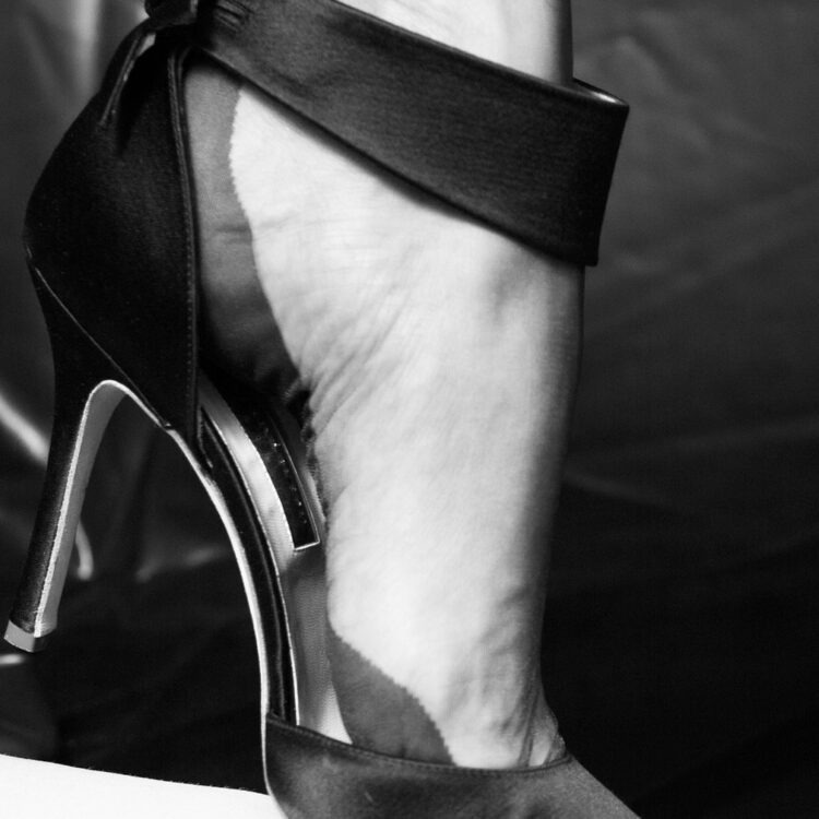 Rupert Sanderson satin high heel and a foot wearing a seamed stocking