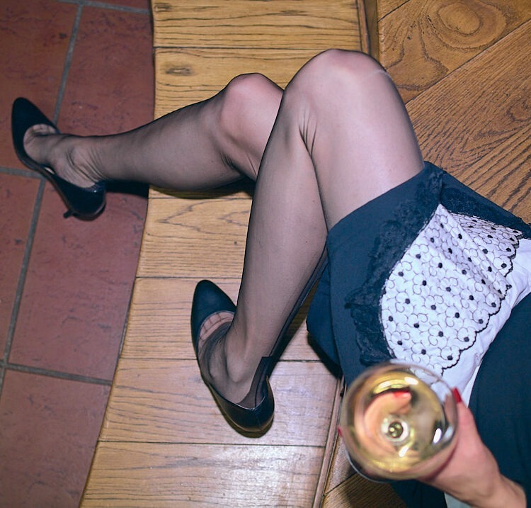 Long stockinged legs of a french maid