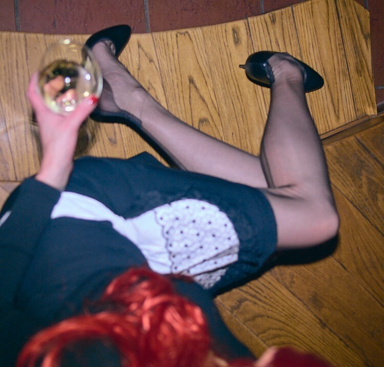 A french mail is sitting an she is wearing Cervin seamed nylon stockings.